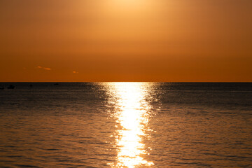 Golden Sunset Over Ocean with Shimmering Water Reflection