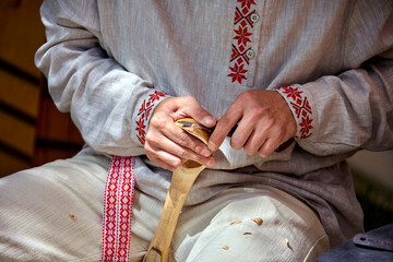 A Craftsman's Delicate Touch: Shaping a Wooden Spoon in a Rustic Workshop