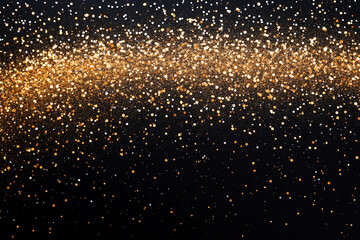 Shimmering gold glitter is scattered on a black background