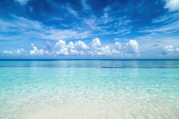 Obraz premium Crystal clear waters under a bright blue sky at the serene beach