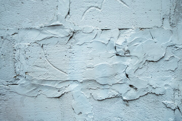 Chaotically placed plaster on white brick as a background.