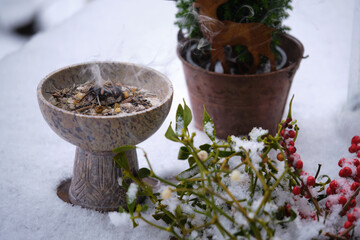 Incense ritual in winter on the terrace – burning resins and herbs on glowing charcoal. Shot...