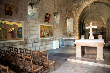 Interior of catholic church Apostle Paul in the city of Damascus. Stone cross, frescoes and icons....