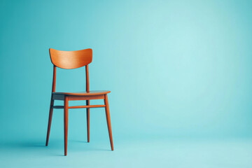 Stylish wooden chair against a blue background.
