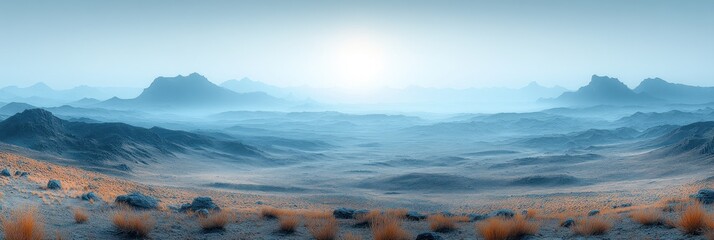 Misty mountain range landscape at sunrise.