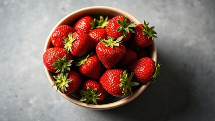 A bowl overflowing with ripe, red strawberries, their vibrant color a testament to summer's bounty.