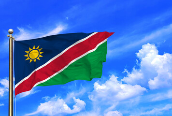 Vibrant Flag of Namibia Waving Against a Clear Blue Sky