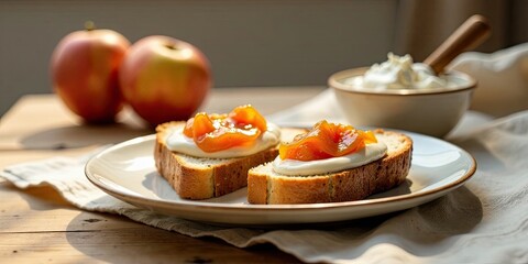 Golden-hued fruit spread atop creamy dairy on toasted bread, a delightful breakfast