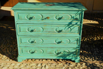 View of an antique turquoise wooden cabinet