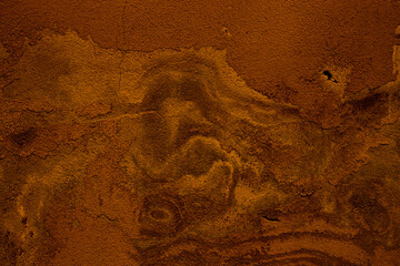 Bronze colored abstract wall background with textures of different shades of orange