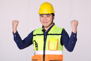 Engineer wearing safety helmet walks to work in industrial plant.