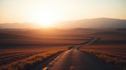 Fototapeta premium Sunset road journey across rolling hills and fields