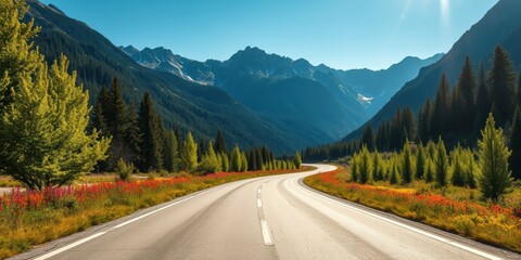 Serene mountain road trip, winding asphalt path through vibrant wildflowers and majestic peaks under a clear sky
