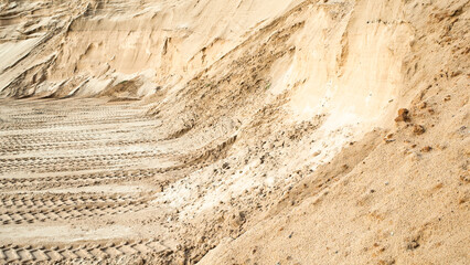 Excavator wheel marks in a sand quarry