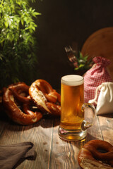 A mug with beer and traditional German bretzels in Bavarian rustic style