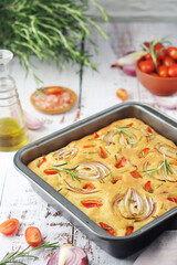Italian home made bread focaccia with tomatoes and onions