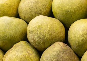 A bunch of green fruit with a fuzzy texture