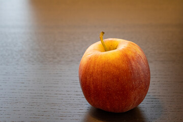 red apple on wooden table