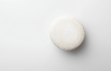 Single white round soap bar on white background.