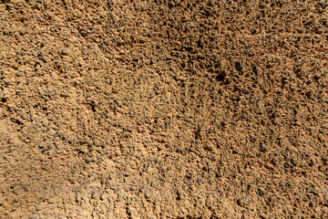 A close up of a wall with a rough, textured surface