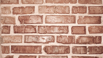 Unique red brick wall with rustic texture and character.