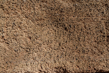 A close up of a wall with a lot of small holes in it