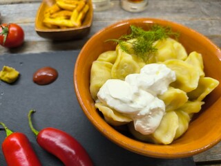 Photo of a plate with dumplings on a wooden table. High quality photos