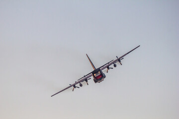 Commanding the Skies.  A military transport aircraft displays its agility in a sharp turn, capturing attention during the twilight hours of the Leszno air show, Poland.