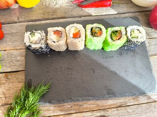 Delicious sushi rolls on a granite chopping board.  View from above.