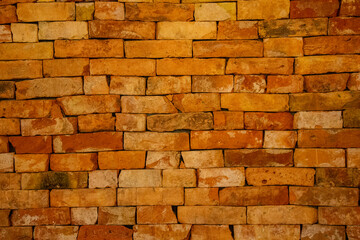 Rustic Brick Wall Texture. A detailed close-up of a rustic brick wall with warm earthy tones, showcasing its rough texture and aged character, perfect for industrial or vintage-themed designs.