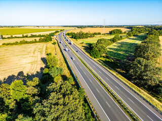 A4 Highway Poland Scenic Drive. Aerial view of the A4 highway in Poland surrounded by vibrant fields, forests, and clear skies, showcasing rural beauty and modern infrastructure.
