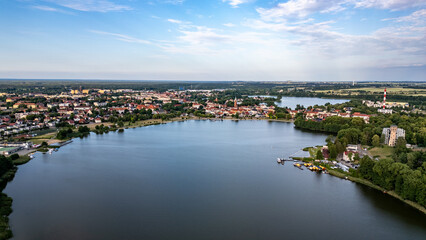 Fototapeta premium Aerial View of Lake Raduń and Wałcz Town, Poland. A breathtaking aerial shot of Lake Raduń with the picturesque Wałcz town, showcasing its serene waters, charming architecture, and natural beauty.