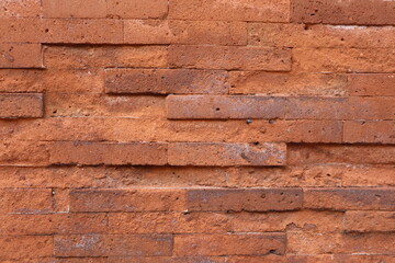 damaged exposed red brick walls