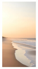Serene beach at sunset with gentle waves and soft sand.