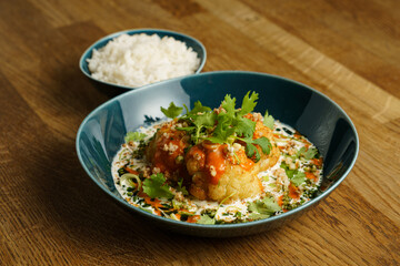 Roasted cauliflower with spicy sauce and herbs