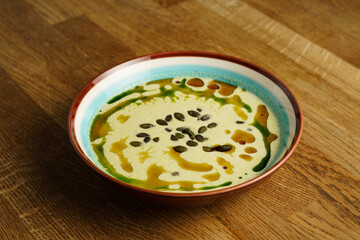 Creamy pumpkin soup with pumpkin seeds and oil drizzle