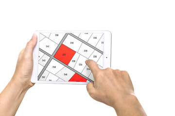 Man holding a tablet looking at lots of lands. Land plot management - real estate concept with vacant land for building construction and housing subdivision for sale, rent, buy, or investment.