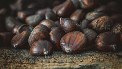 Chestnut harvest macro view arranged on a wooden table. Rustic still life

