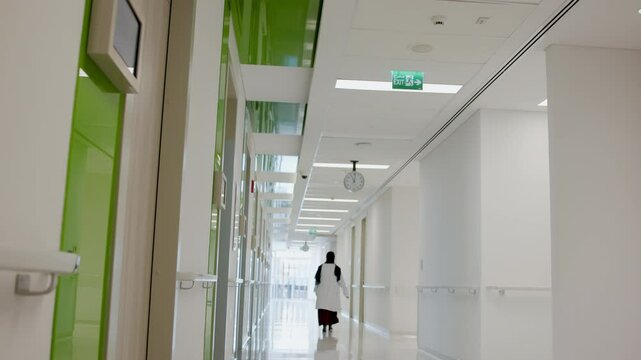 An Arab doctor walks in the hospital corridor