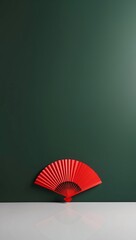 Red Hand Fan Against Emerald Green Wall Minimalist  Asian Design Aesthetic Still Life Photography