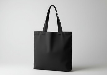 Black tote bag, simple design, canvas material, sturdy handles, minimalist aesthetic, eco