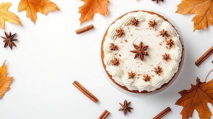 A decorated cake surrounded by autumn leaves and spices, perfect for seasonal celebrations.