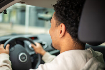 Close-up of man driving a car in city