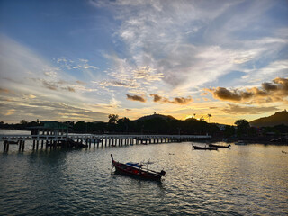 A beautifully serene view of a stunning sunset with fishing boats