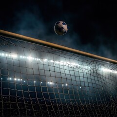 football goalpost illuminated by the stadium lights, with the ball heading straight for the net,