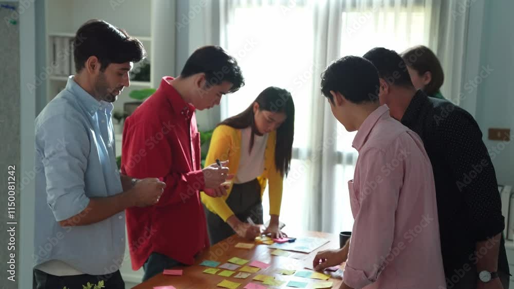 Poster Top view of smart business team brainstorm idea while writing idea in colorful sticky notes. Attractive diverse people in casual cloth planning strategy and brainstorming marketing plan. Convocation.