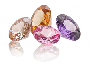 Fototapeta premium Assorted Gemstones Displayed on a Reflective Surface in Various Colors Including Pink, Purple, Orange, and Clear, Showcasing Their Brilliant Cuts and Luster