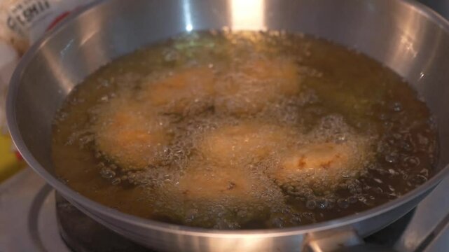 Frying combro using a frying pan with full hot oil, combro is a traditional cake from Indonesia as a snack