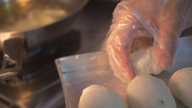 Frying combro using a frying pan with full hot oil, combro is a traditional cake from Indonesia as a snack