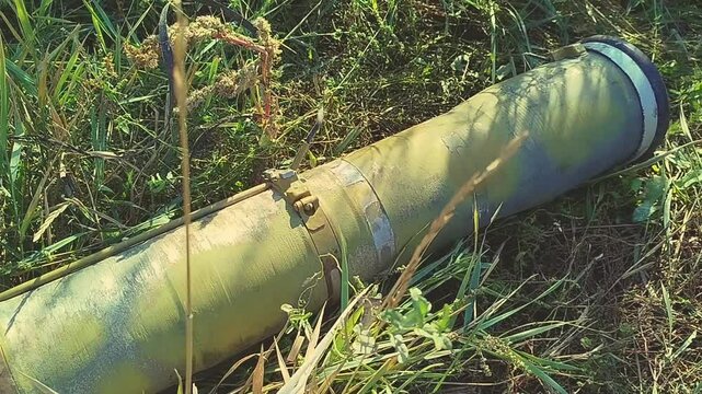 Unexploded shells lie on the ground. Large aerial bombs lie in the crater from the explosion. High quality